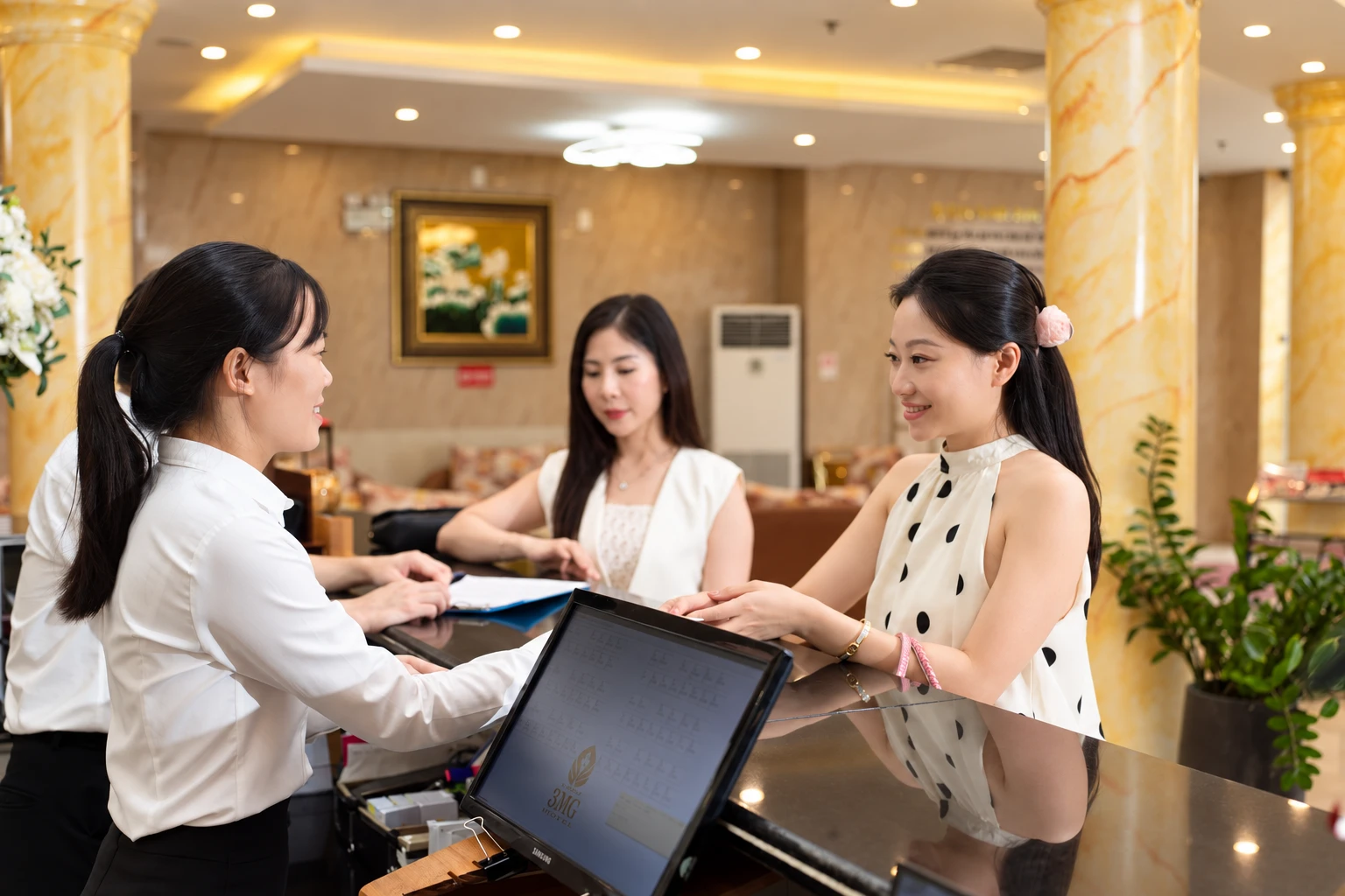The reception team welcoming guests at 3MG Lakeside Hotel