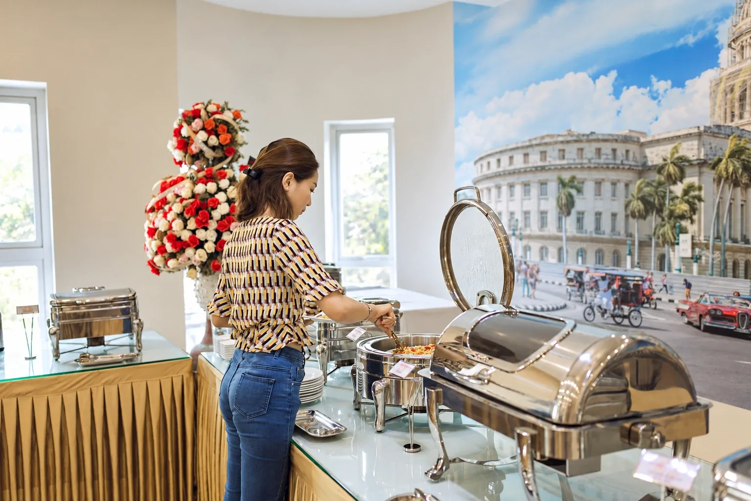 A guest choosing food at the restaurant buffet